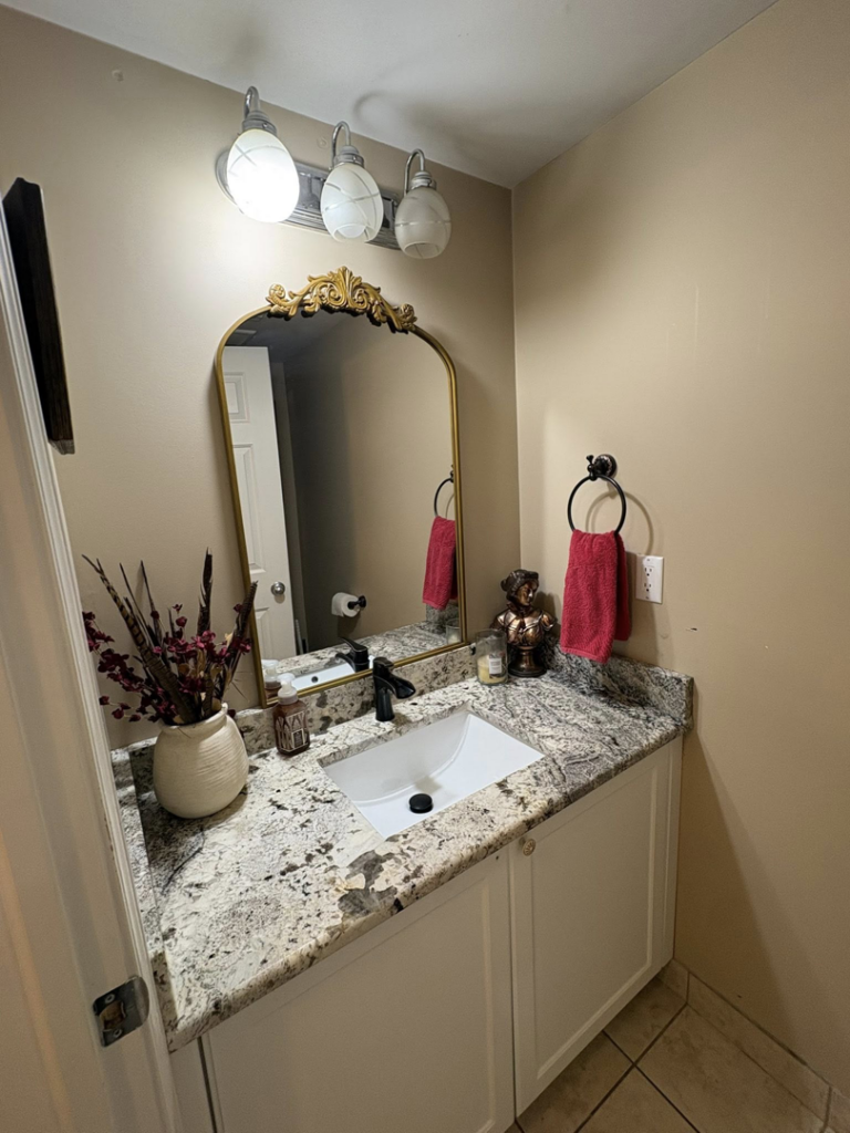 A clean bathroom vanity with a white sink and granite countertop, maintained by HDew Cleaning Co. in Madison Heights, MI.