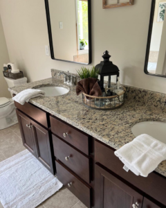 A beautifully clean bathroom vanity with two sinks and fresh towels, showcasing the results of Mary's Sparkling Cleaning in Fall River, MA.