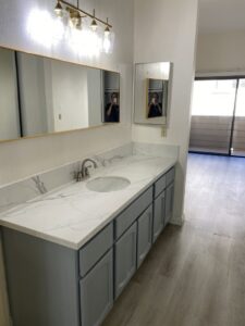 A clean bathroom vanity with a spotless countertop and mirror, cleaned by Maid 2 Clean San Diego, CA