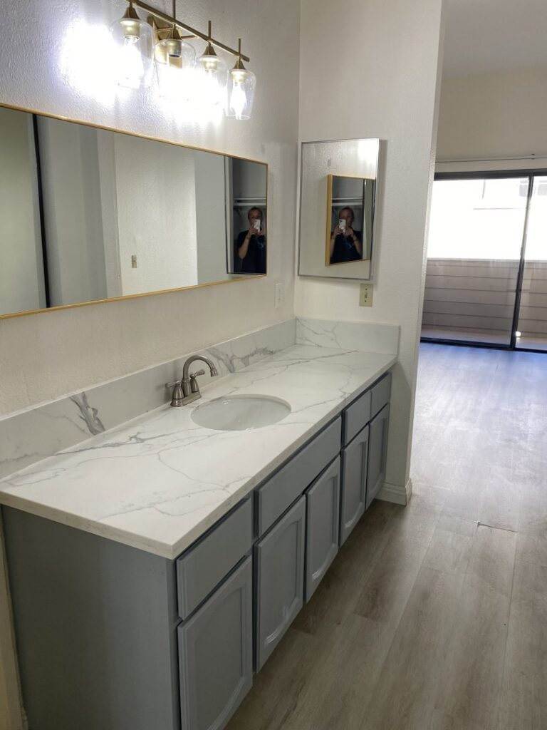 A clean bathroom vanity with a spotless countertop and mirror, cleaned by Maid 2 Clean San Diego, CA