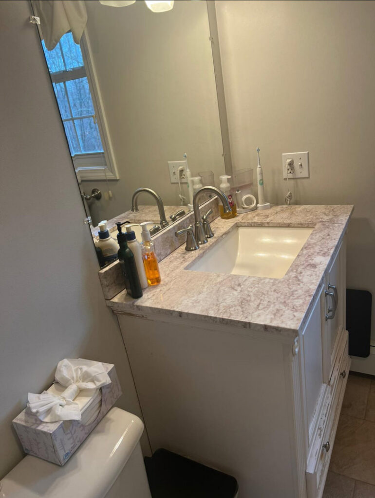 A clean bathroom vanity with a polished sink and mirror, reflecting the thorough cleaning provided by Mary's Sparkling Cleaning in Fall River, MA.