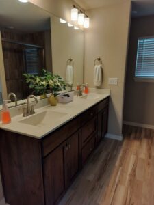 A beautifully clean bathroom vanity with dual sinks and polished fixtures, a result of Peoria Cleaning Pros, LLC in East Peoria, IL.