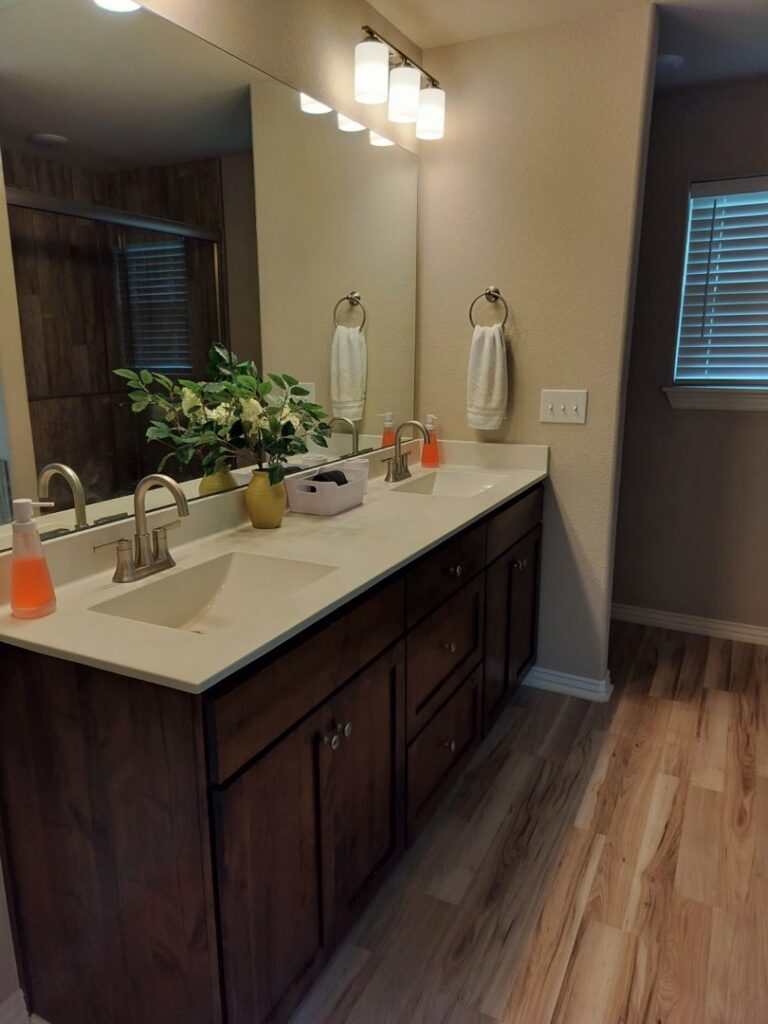A beautifully clean bathroom vanity with dual sinks and polished fixtures, a result of Peoria Cleaning Pros, LLC in East Peoria, IL.