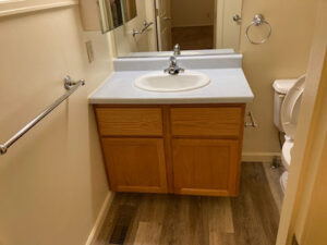 A clean bathroom vanity with a single sink and mirror, showcasing detailed cleaning services by 307 Maid in Cheyenne, WY.