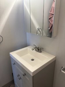 A meticulously cleaned bathroom vanity and sink, reflecting the professional house cleaning by Cleaning with Kay in Syracuse, NY.