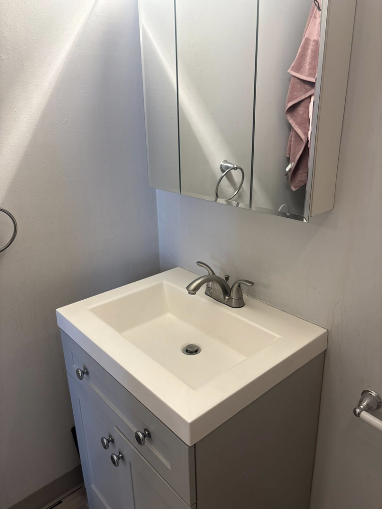 A meticulously cleaned bathroom vanity and sink, reflecting the professional house cleaning by Cleaning with Kay in Syracuse, NY.