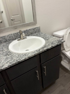 A sparkling clean bathroom vanity and sink, expertly cleaned by Jess Cleaning in San Antonio, TX.