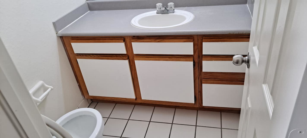 A sparkling clean bathroom vanity and sink, demonstrating the thorough cleaning services of Solid Rock Cleaning Company LLC in Orlando, FL