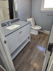 A clean bathroom with a modern vanity and toilet after professional cleaning by Hm General Cleaning Services in Schenectady, NY