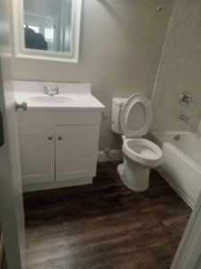 A fully cleaned bathroom featuring a sparkling vanity, toilet, and bathtub, showcasing the comprehensive services of Dacari's Helping Hands LLC in South Bend, IN.