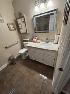 A pristine bathroom featuring a clean vanity, toilet, and tiled floor, cleaned by Cleaning Service Masters LLC in Escondido, CA