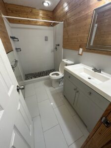 A clean bathroom featuring a vanity, toilet, and shower, showcasing the professional cleaning by CLEAN That SHEET LLC in Jacksonville, FL.