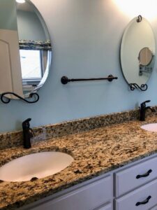 A spotless bathroom vanity with double sinks and mirrors, cleaned by Price Cleaning Services Omaha in Council Bluffs, IA.