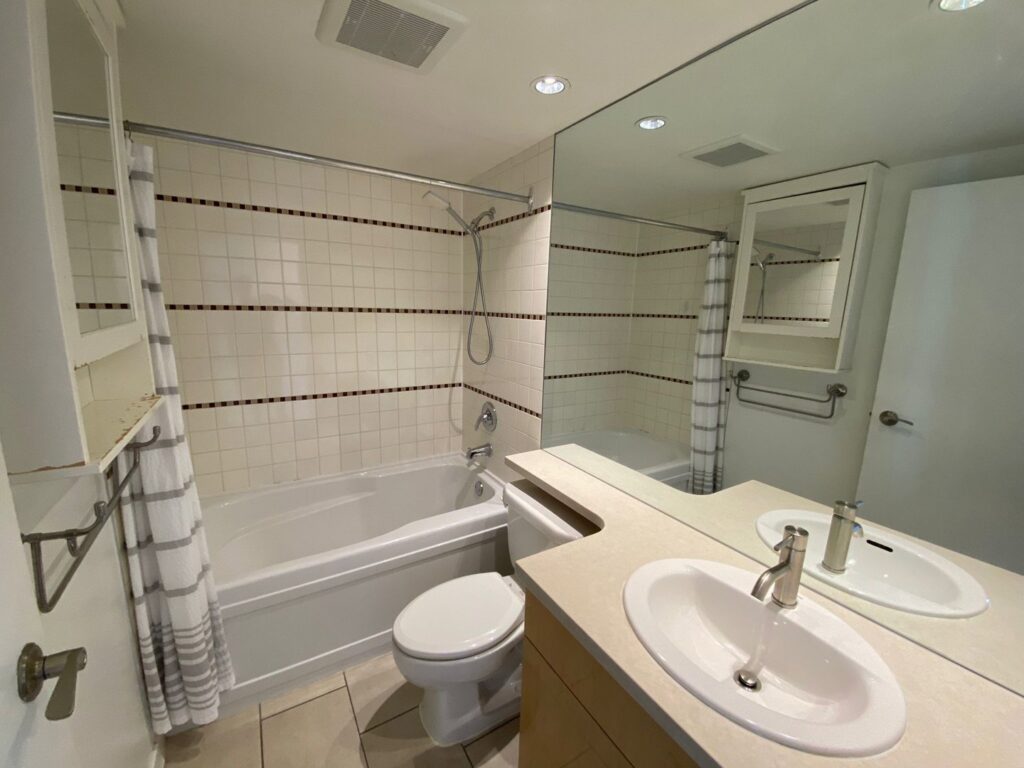 A pristine clean bathroom featuring a bathtub, toilet, and vanity, cleaned by Trust-Clean in Green Bay, WI.