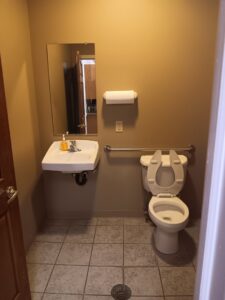 A clean bathroom featuring a toilet and sink, showcasing the thorough cleaning by Faye Cleaning Service LLC in Ankeny, IA.