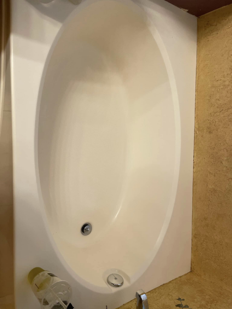 A sparkling clean bathtub after a professional cleaning service by Maid It Dirty Cleaning Company in Phoenix, AZ.