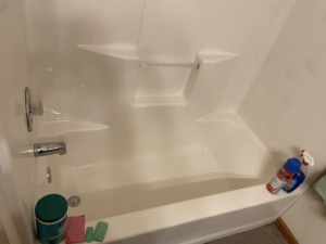 A freshly cleaned bathtub with cleaning supplies nearby, demonstrating the thorough work of Sara's House Cleaning in Olathe, KS.