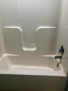 A sparkling clean bathtub in a residential bathroom, showcasing the quality work of Price Cleaning Services Omaha in Council Bluffs, IA.