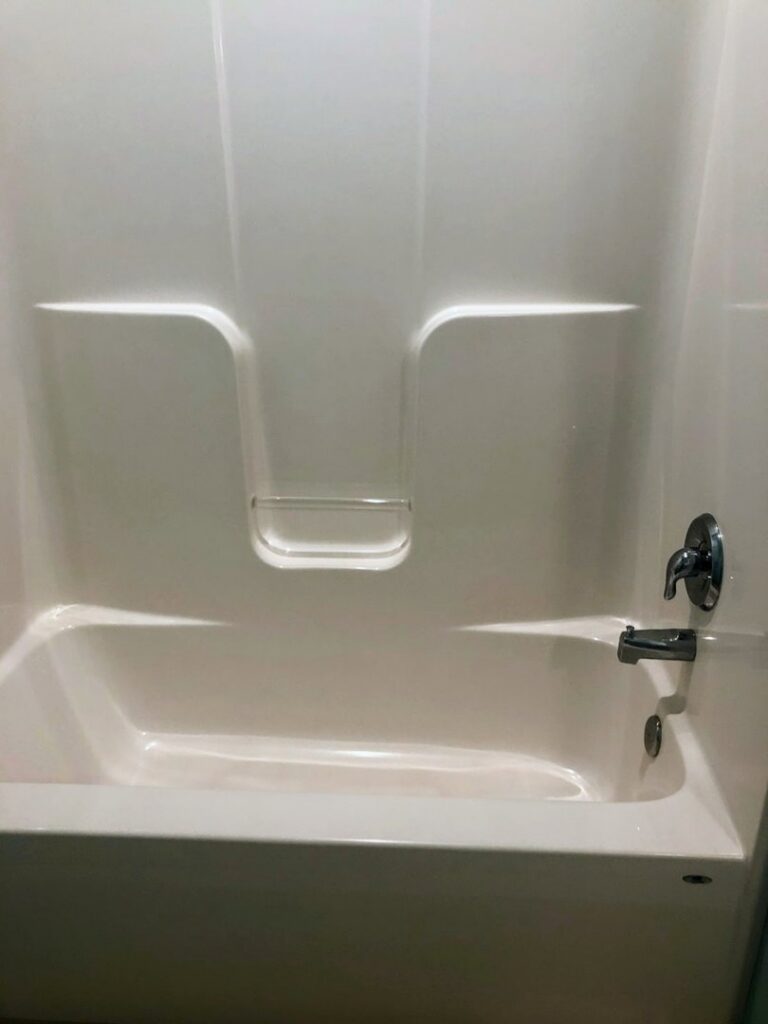 A sparkling clean bathtub in a residential bathroom, showcasing the quality work of Price Cleaning Services Omaha in Council Bluffs, IA.