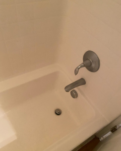 A pristine clean bathtub and shower area, demonstrating the thorough bathroom cleaning by Touches of Grace Cleaning Services in Virginia Beach, VA.