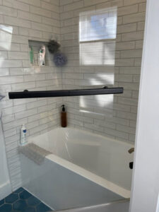 A spotless bathtub with modern subway tiles, reflecting the quality house cleaning by Straight Up Cleaning in South Portland, ME.