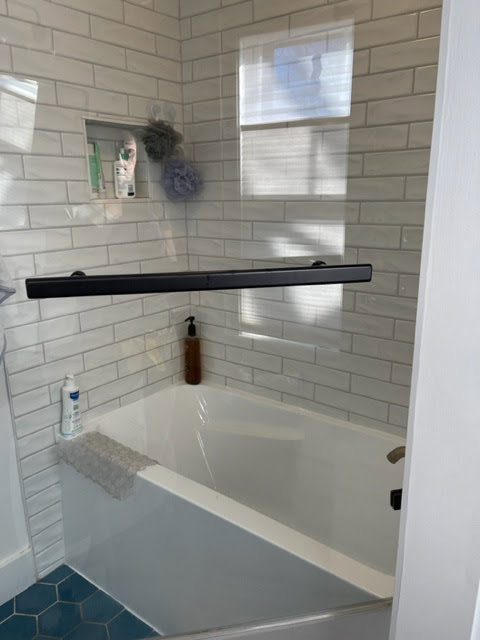 A spotless bathtub with modern subway tiles, reflecting the quality house cleaning by Straight Up Cleaning in South Portland, ME.