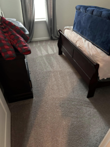 A clean bedroom floor with vacuum lines, serviced by Five Star Cleaning Service in Pasadena, MD.