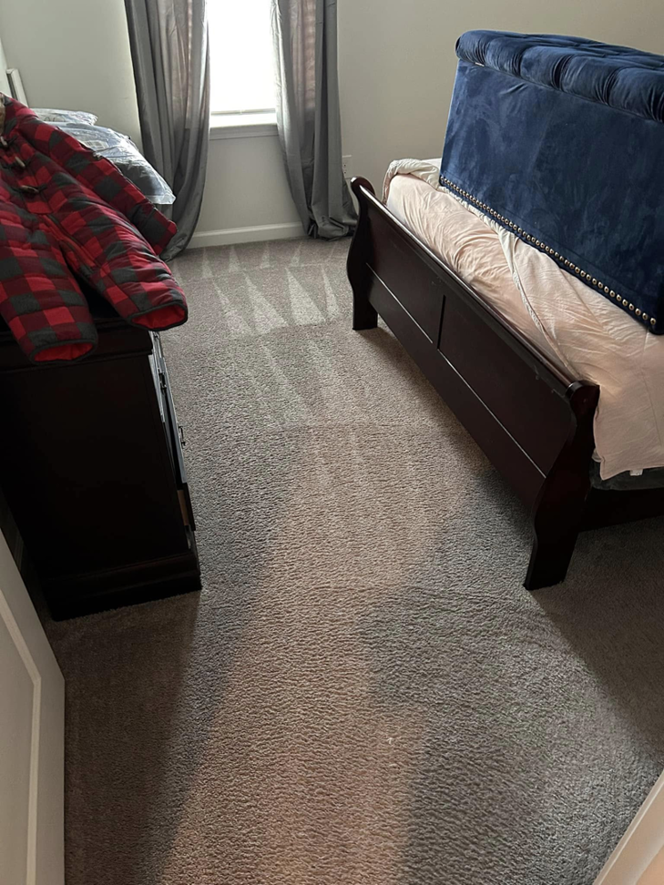 A clean bedroom floor with vacuum lines, serviced by Five Star Cleaning Service in Pasadena, MD.