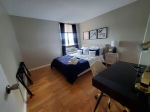 A professionally cleaned bedroom with neatly folded white towels on the bed, demonstrating the attention to detail by Maids of Hartford in Hartford, CT.