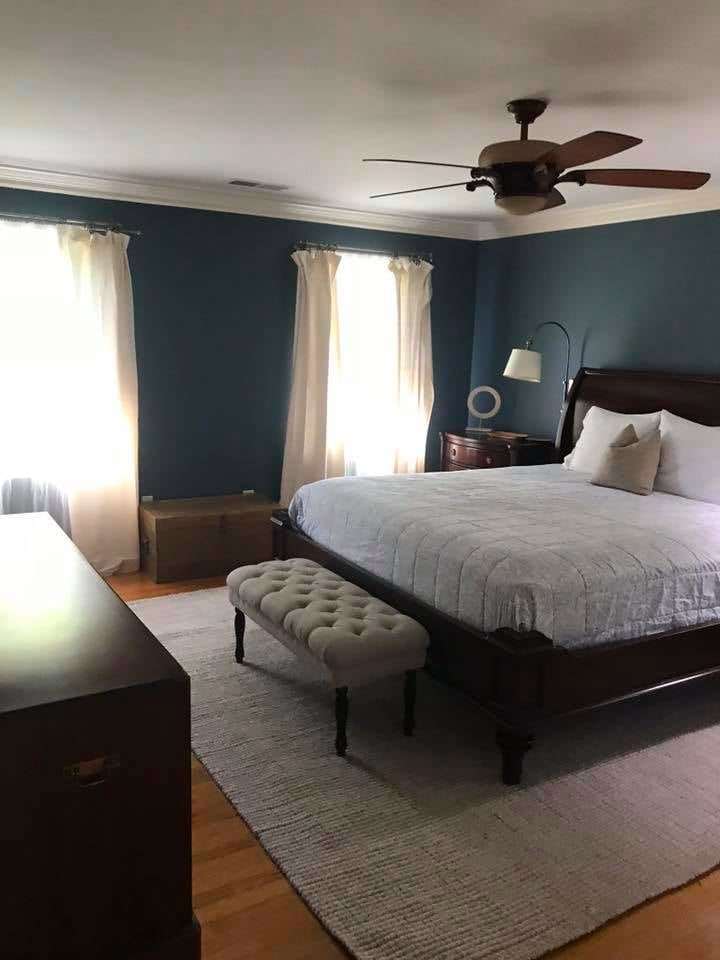A neatly made and clean bedroom, showcasing house cleaning service results by A'La Carte Clean in Virginia Beach, VA.