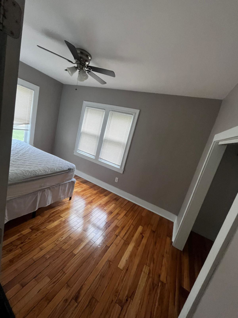 A sparkling clean bedroom with polished wooden floors after a move-out cleaning by Sophia's Cleaning service LLC in Manassas, VA.