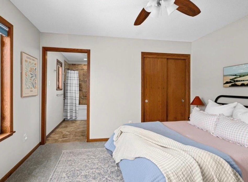A sparkling clean bedroom with a neatly made bed, showcasing the quality house cleaning by Tidy Details in Duluth, MN.