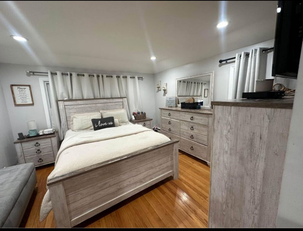 A beautifully cleaned bedroom with a polished wooden floor and light furniture, by Trust-Clean in Green Bay, WI.