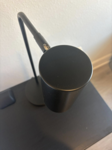 A dust-free black desk lamp, shining brightly after cleaning by Saari's Cleaning Services LLC in Jacksonville, FL.