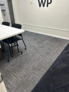 A clean floor with grey carpet tiles, maintained by Green Leaf Janitorial in Gilbert, AZ.