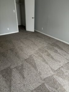 A freshly cleaned carpeted bedroom with light grey walls, ready for occupancy by Bee Clean Solutions in Lexington, KY.