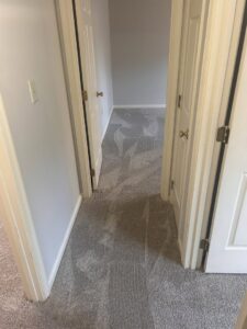A clean carpeted hallway leading to rooms, demonstrating house cleaning services by Time To Shine Cleaning Services in Round Rock, TX.
