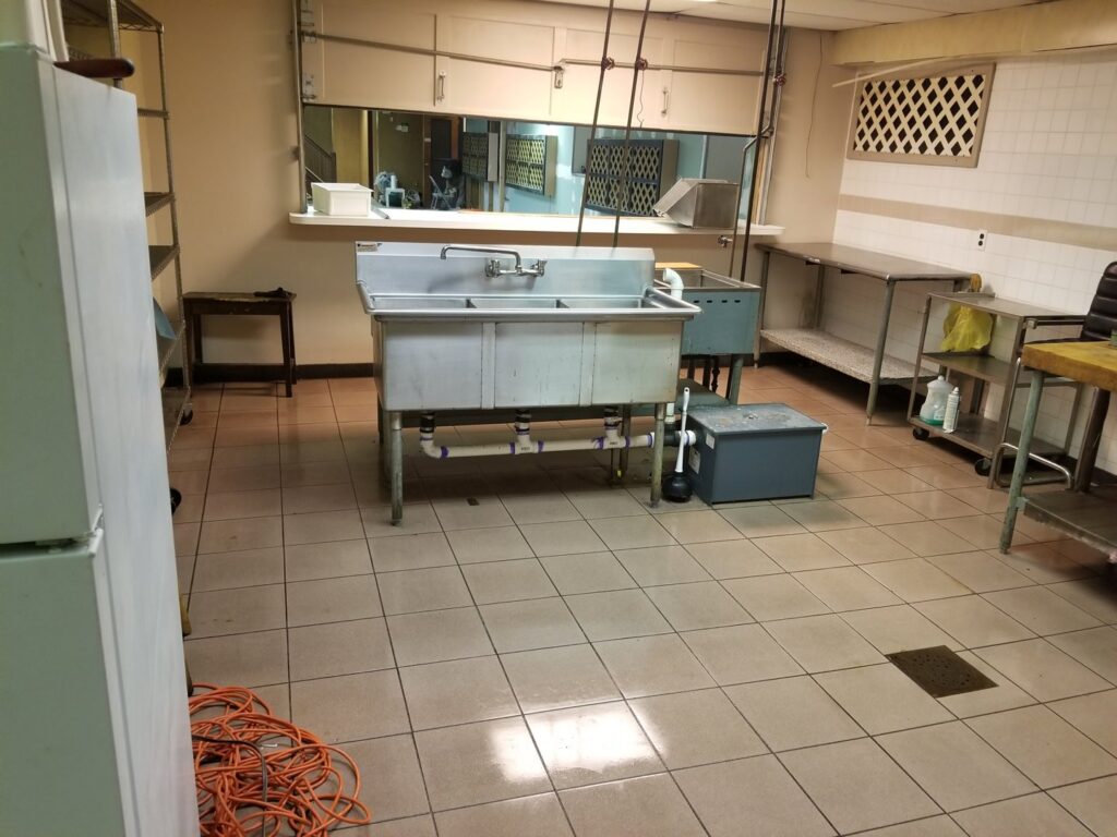 A sparkling clean tiled floor in a commercial kitchen by Cooper-N-Folks in Philadelphia, PA