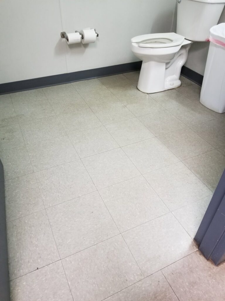 A clean and shiny tiled floor in a commercial restroom by Cooper-N-Folks in Philadelphia, PA