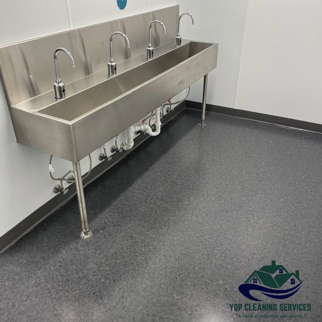A spotless commercial-style stainless steel sink area, demonstrating the detailed cleaning by YQP Cleaning Services in Miami, FL.