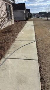 A clean concrete pathway after professional power washing service by Plains Power Washing in Auburn, AL.
