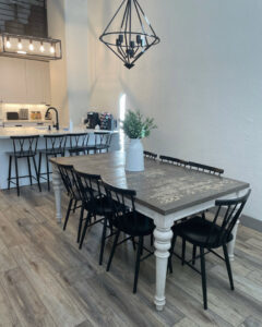 A spacious and clean dining area with a large wooden table and modern chairs, showcasing house cleaning by Cleans by Roseileen LLC in Louisville, KY.