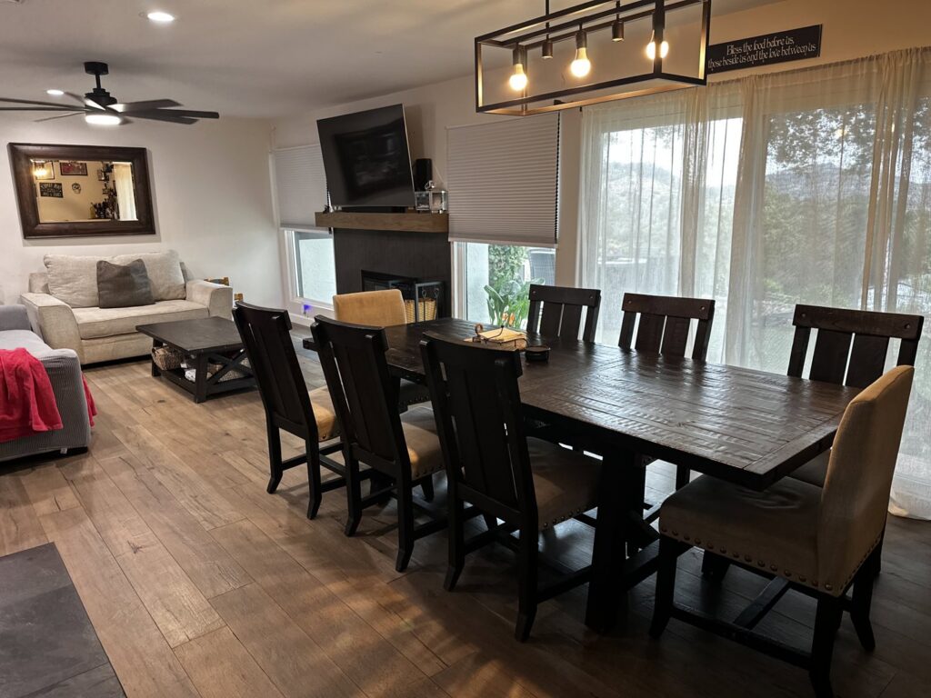 A spacious and clean dining and living room area with gleaming wooden floors, cleaned by Cleaning Service Masters LLC in Escondido, CA