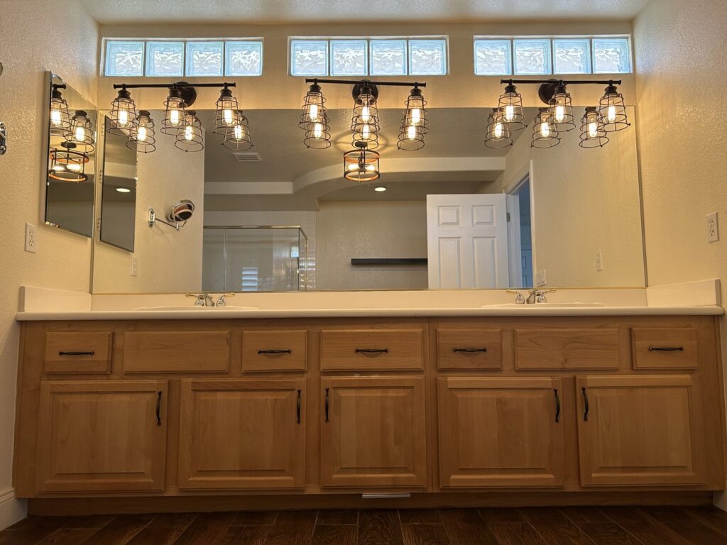 A clean double vanity with two sinks and mirrors in a bathroom, showcasing cleaning by JG Clean Solutions in Henderson, NV.