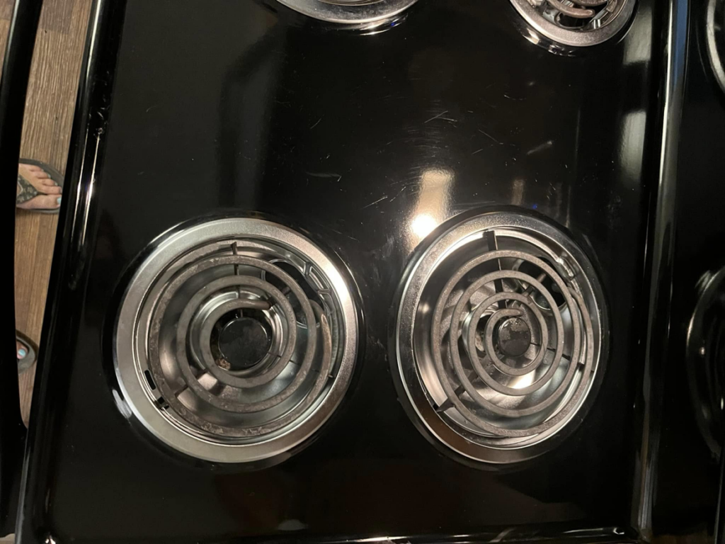 Close-up of sparkling clean electric stovetop burners after a professional cleaning by You have it maid in Canton, MI.