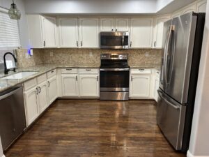 A sparkling clean kitchen with wood floors and white cabinets, showing a move-out cleaning by Phoenix Move Out House Cleaning Pros in Chandler, AZ