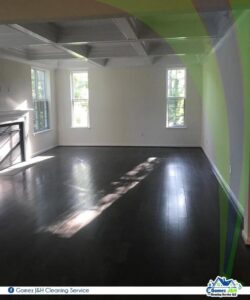 A spotless, empty living room with dark hardwood floors after professional cleaning by Gomez J&H Cleaning Service, LLC in Parkville, MD