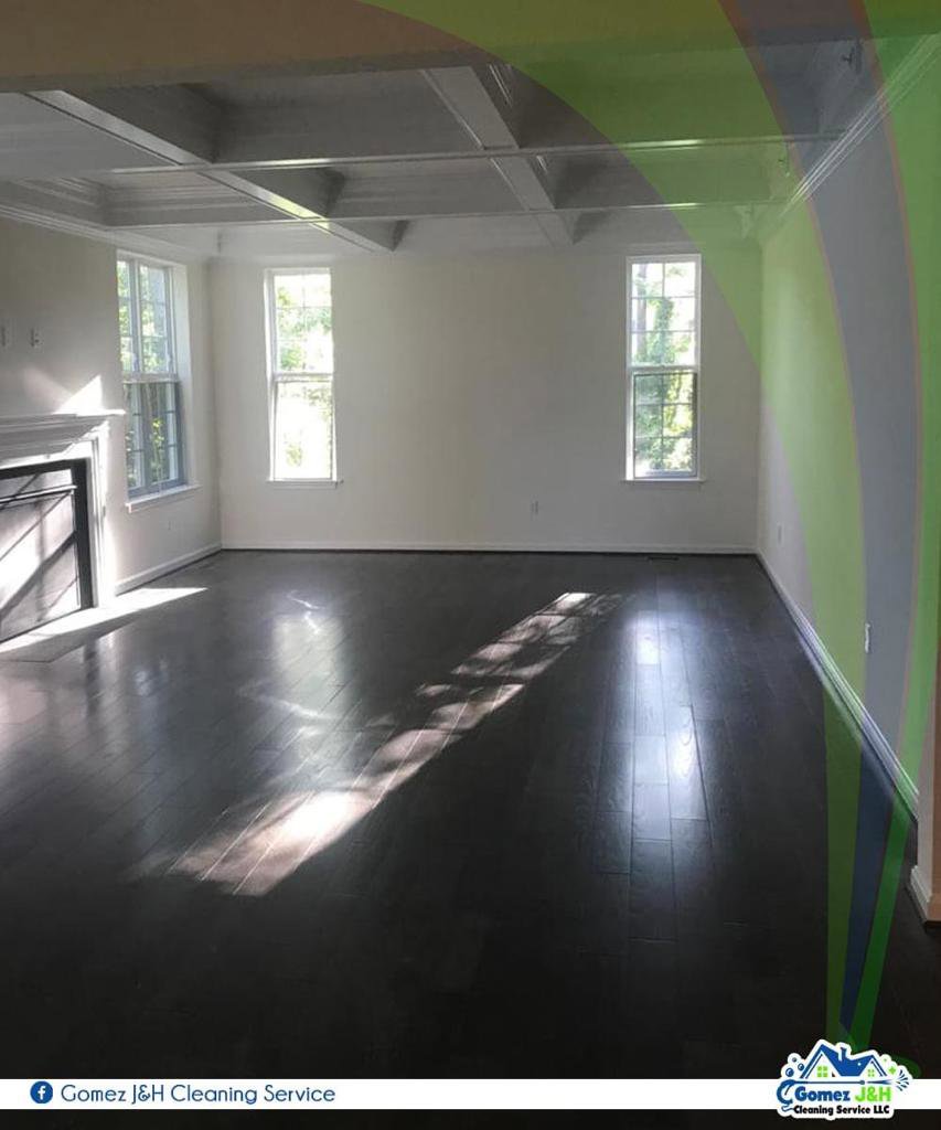 A spotless, empty living room with dark hardwood floors after professional cleaning by Gomez J&H Cleaning Service, LLC in Parkville, MD