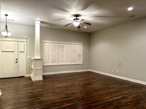 A clean and tidy empty living room with polished hardwood floors, reflecting the quality service of Sudz Up Cleaning Company in Columbia, MO.