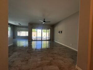 A clean, empty living room with shiny tile floors, representing a move-out cleaning service by Phoenix Move Out House Cleaning Pros in Chandler, AZ
